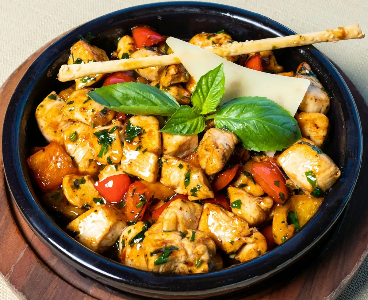 Chicken and rice skillet with herbs in a shallow pan